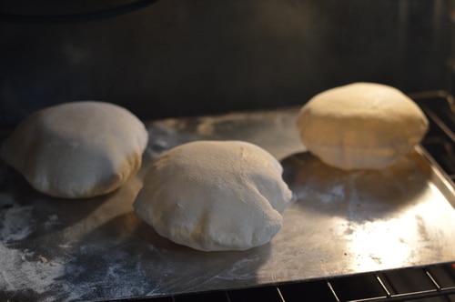 Pita bread is just the right size for a sandwich. Better than a bun, it doesn't get soggy when loaded down with tzatziki, hummus, or lamb and hot sauce. Pita bread is a must for gyros and schwarma. And it's pretty quick to make. You don't even need to wait for the bread to rise a second time before you bake it.