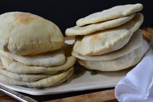 Pita bread is just the right size for a sandwich. Better than a bun, it doesn't get soggy when loaded down with tzatziki, hummus, or lamb and hot sauce. Pita bread is a must for gyros and schwarma. And it's pretty quick to make. You don't even need to wait for the bread to rise a second time before you bake it.
