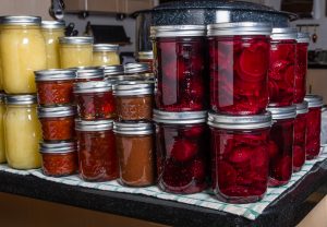 Preserved foods in mason jars on a counter