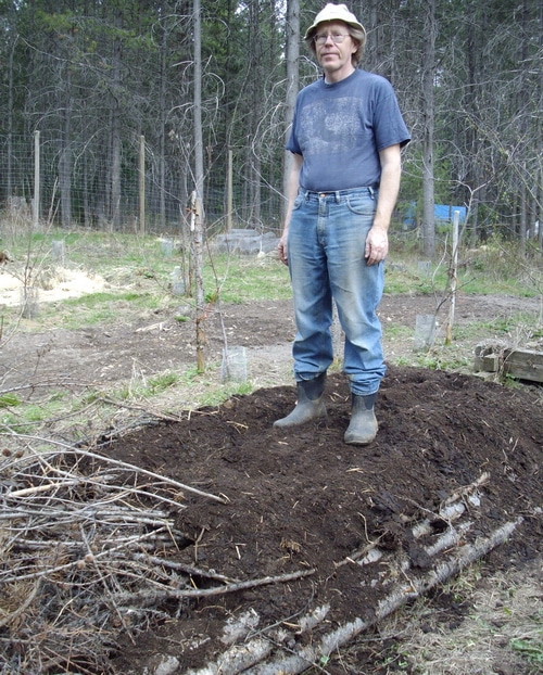 The 3rd layer is half finished compost Stomp it down to get it in between the wood base. The more solid that you pack it the better.