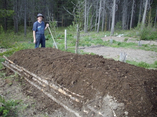 The final layer is finished compost. Your hugelkultur bed is ready to plant immediately.