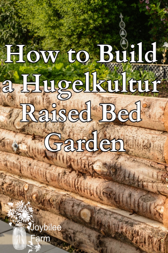 side of a raised wooden bed with text "how to build a hugelkultur raised bed garden"