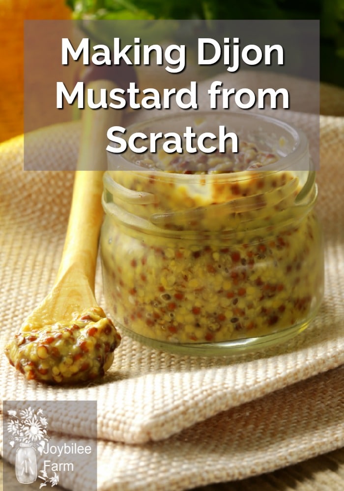 Glass jar of dijon mustard