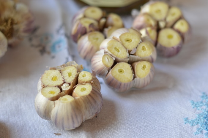 Roasted garlic is sweet, and complex, without the burning sensation of raw garlic. Roasted garlic has been cooked at low temperatures that caramelize the sugars, naturally occurring in all alliums. This gives roasted garlic a complex, delicious, warmth, not found on the supermarket shelf. Top chefs know this and incorporate roasted garlic in sauces, soups, dips, and meat dishes. But you don't have to spend big money at a fancy restaurant to enjoy the flavours of roasted garlic. It's easy to make it at home, and doesn't even take extra time.