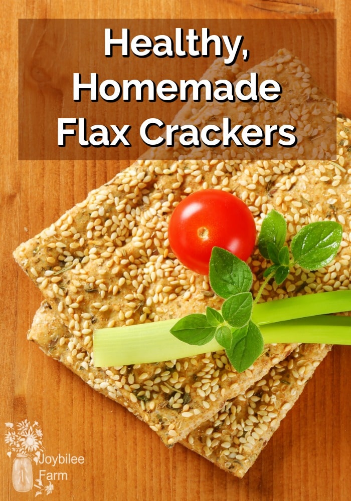 Sesame crackers stacked with a cherry tomato and celery on top