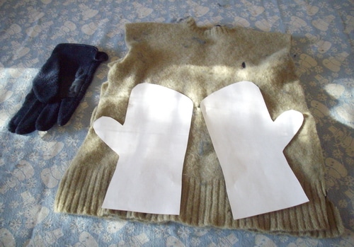 Mittens laying out pattern on sweater