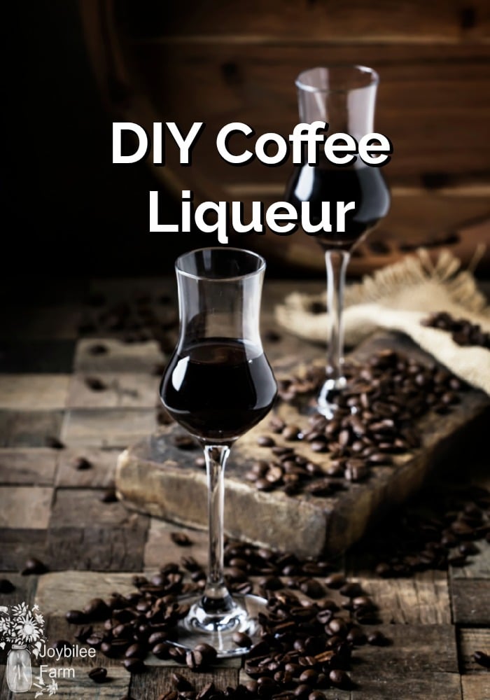 Two flutes of coffee liqueur with coffee beans scattered around