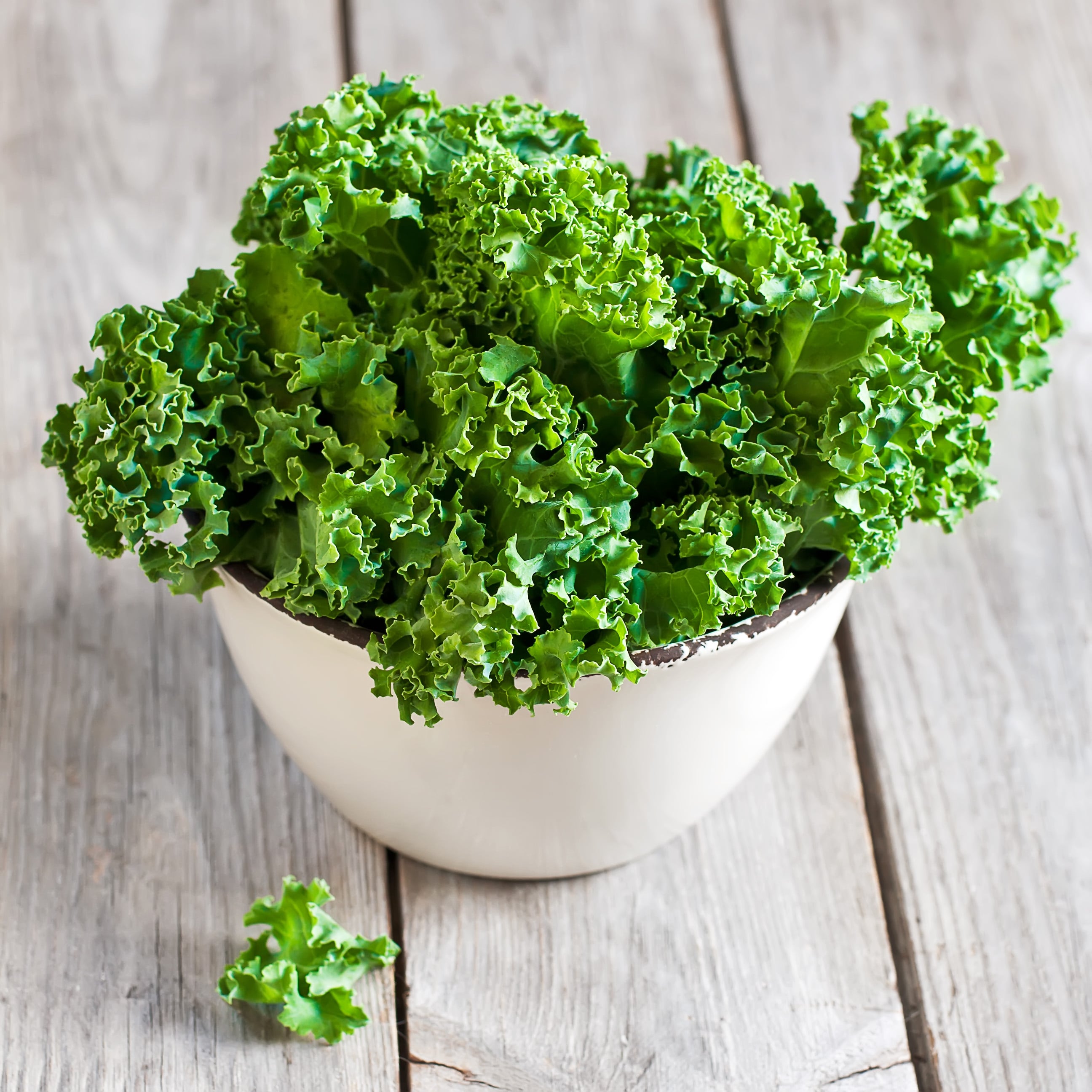 Fresh green kale in a white bowl