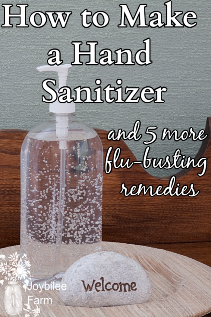 hand sanitizer in a clear bottle with a stone with 'welcome' on it on a wooden tray.