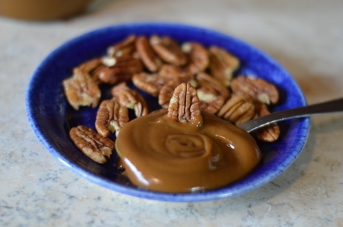 Dulce de leche (sweet made of milk) is a caramel sauce made with sweet milk and heavy cream. In this Dolce de leche recipe I’m using whey left over from cheese making and condensed with slow cooking to create the caramel. Whey contains most of the sugar found in milk, in the form of lactose. Therefore making dulce de leche from whey, after cheese making, is an economical and efficient use of your homestead milk. The final caramel sauce has a complex flavour that is reminiscent of salted caramels. It requires patience as the whey is cooked very slowly much like maple syrup is cooked down from maple sap. It is reduced over low heat by 80%, while the lactose in the whey caramelises. Use dulce de leche as a topping for ice cream, pour it over cheese cake, spoon it into pecan tarts or pour it over custard. Cook it a little longer and you will have fudge or toffee. Whey candy is a treat!