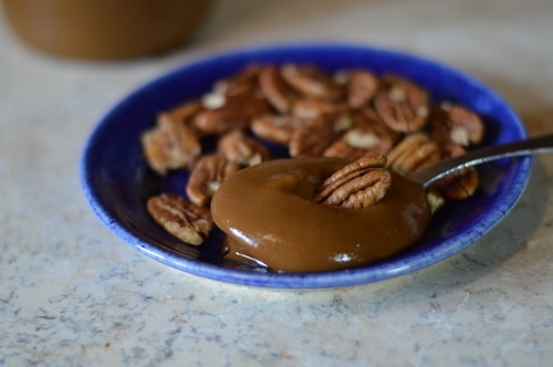 Dulce de leche (sweet made of milk) is a caramel sauce made with sweet milk and heavy cream. In this Dolce de leche recipe I’m using whey left over from cheese making and condensed with slow cooking to create the caramel. Whey contains most of the sugar found in milk, in the form of lactose. Therefore making dulce de leche from whey, after cheese making, is an economical and efficient use of your homestead milk. The final caramel sauce has a complex flavour that is reminiscent of salted caramels. It requires patience as the whey is cooked very slowly much like maple syrup is cooked down from maple sap. It is reduced over low heat by 80%, while the lactose in the whey caramelises. Use dulce de leche as a topping for ice cream, pour it over cheese cake, spoon it into pecan tarts or pour it over custard. Cook it a little longer and you will have fudge or toffee. Whey candy is a treat!