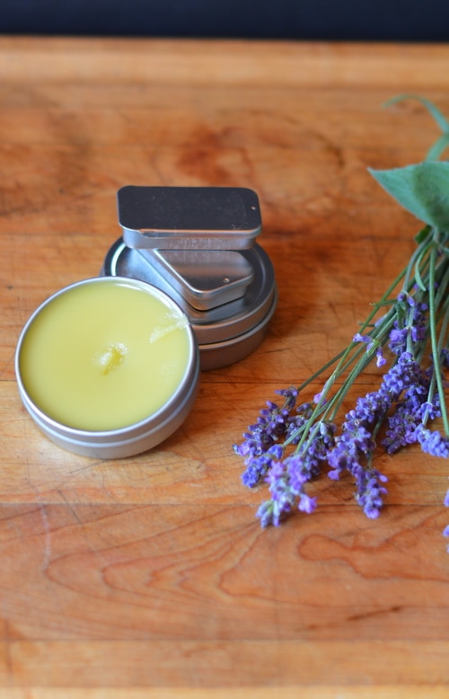 This soothing headache salve can be made from fresh lavender blossoms and peppermint leaves from your garden. If you don’t have any in your garden you can use dried leaves and dried blossoms to make this. The fragrance will be barely noticable in the finished salve but the herbs will contribute their herbal actions when in contact with the skin. The aromatic essential oils give the fragrance to this salve rather than the herbs.