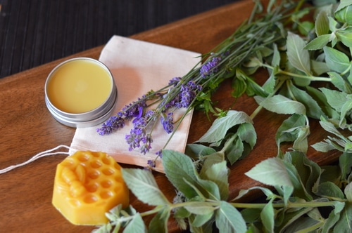 This soothing headache salve can be made from fresh lavender blossoms and peppermint leaves from your garden. If you don’t have any in your garden you can use dried leaves and dried blossoms to make this. The fragrance will be barely noticable in the finished salve but the herbs will contribute their herbal actions when in contact with the skin. The aromatic essential oils give the fragrance to this salve rather than the herbs.
