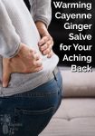 A man holding his sore back.
