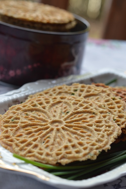 Savory pizzelles are better than the finest, high end store-bought cracker. A base of eggs, butter, flour, and baking powder can be spiced up with grated cheese, sesame seeds, flax seed, nuts, onions, garlic, fresh herbs, lemon peel, or spices. And the recipe is enough to please 4 to 6 people for appetizers. Double the recipe for a bigger audience.