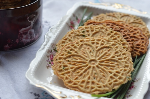 Savory pizzelles are better than the finest, high end store-bought cracker. A base of eggs, butter, flour, and baking powder can be spiced up with grated cheese, sesame seeds, flax seed, nuts, onions, garlic, fresh herbs, lemon peel, or spices. And the recipe is enough to please 4 to 6 people for appetizers. Double the recipe for a bigger audience.