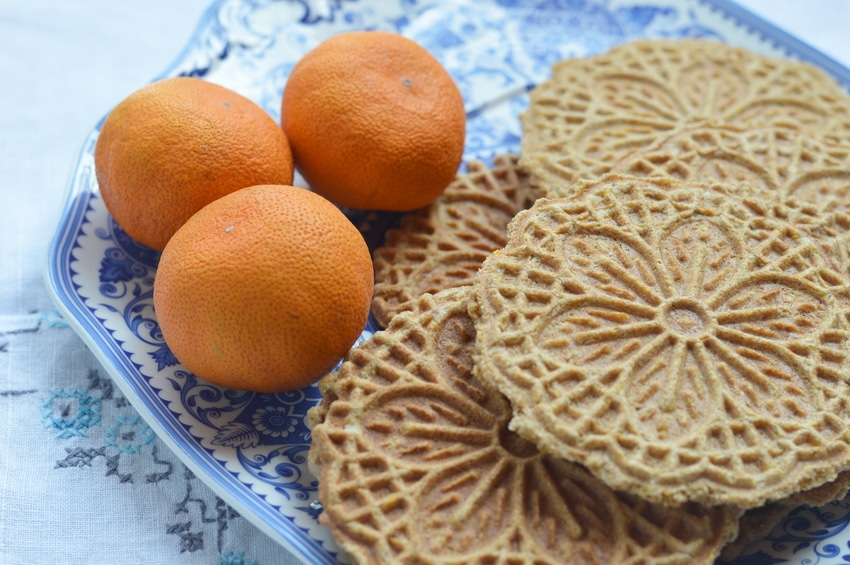 Pizzelles are an Italian wafer cookie made with a special iron press that squishes the cookie batter between two decorative plates, and then heats it to a crisp cookie texture, much like a waffle cone. Pizzelles are quick to make, and not too sweet. Commonly served with espresso they are a light treat that won’t overwhelm.