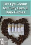 Tubes of homemade eye cream surrounded by coffee beans in the shape of a heart
