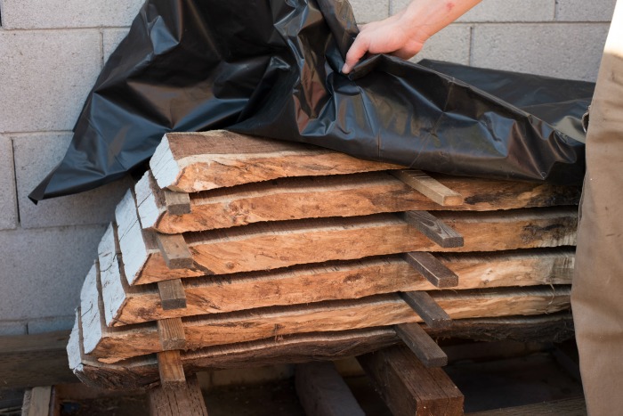 When a tree falls in an urban area a DIYer will mill it and then dry it using these best practices to season lumber from downed trees.