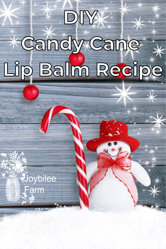 snowman with candy cane on wooden background