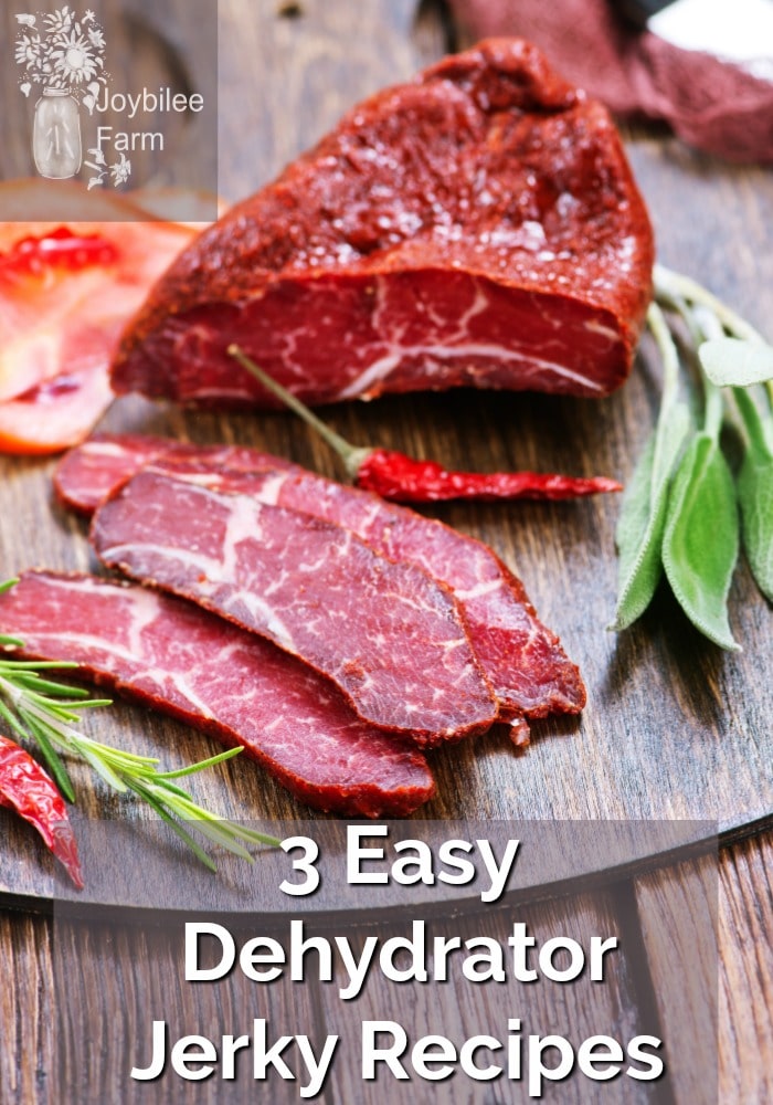 Beef sliced on a board with spicy peppers and herbs