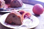 cake on white dish with blood orange garnish