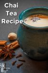 cup of chai tea by spices on table