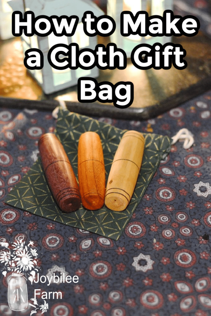 Needle cases on top of a handmade cloth gift bag