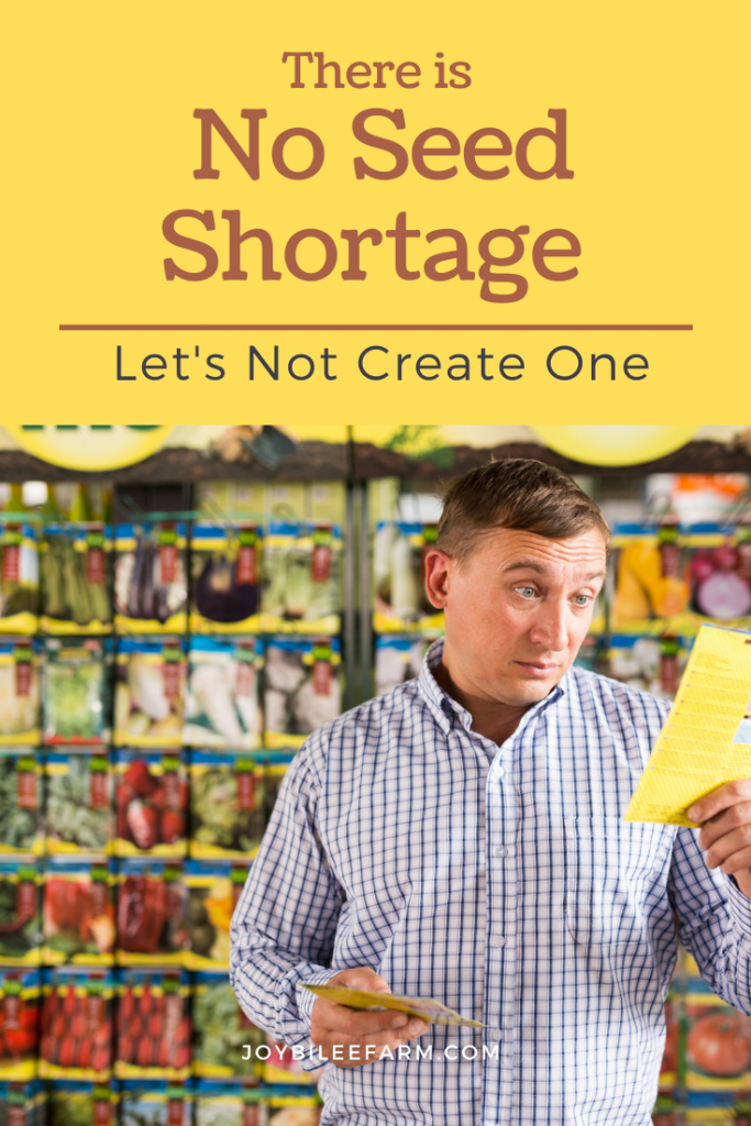 Man holding a shopping list in front of a seed rack