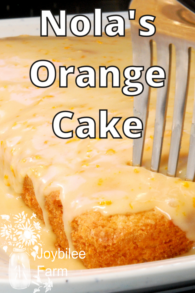 tasty orange cake, with a fork in it to take a bite